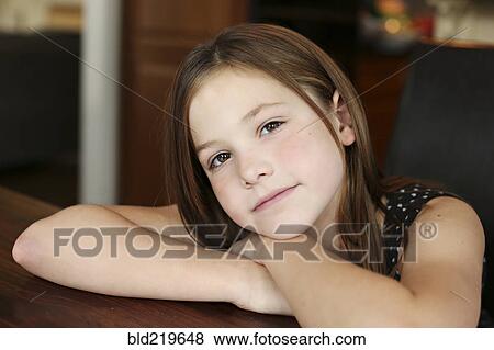 Close up of serious girl resting chin on hand View Large Photo Image Stock Photo - Close up of serious girl resting chin on hand. Fotosearch