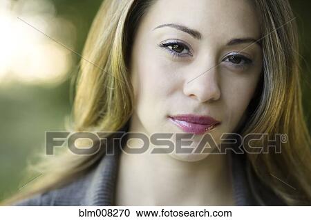 Stock Image - Close up of serious Hispanic woman. Fotosearch