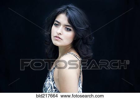 Picture - Close up of serious mixed race woman. Fotosearch