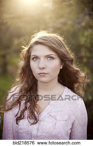 Close up of serious woman in field View Large Photo Image Stock Photograph - Close up of serious woman in field. Fotosearch