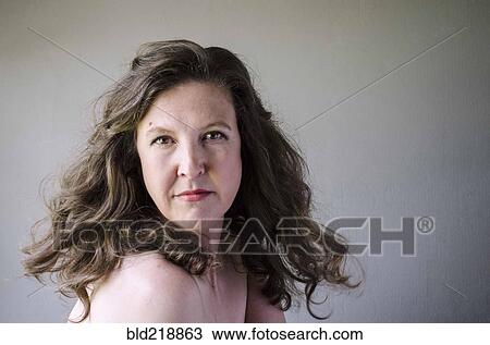 Close up of serious woman twirling hair View Large Photo Image Stock Image - Close up of serious woman twirling hair. Fotosearch