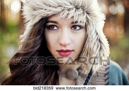 Close up of serious woman wearing furry hat View Large Photo Image Stock Photo - Close up of serious woman wearing furry hat. Fotosearch