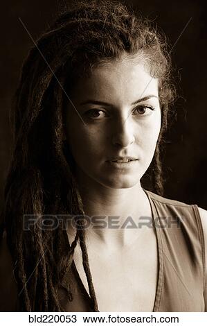 Stock Image - Close up of serious woman with dreadlocks. Fotosearch