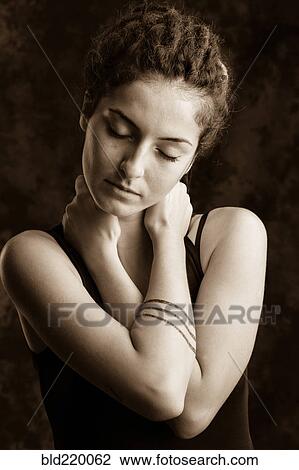 Stock Image - Close up of serious woman with dreadlocks. Fotosearch