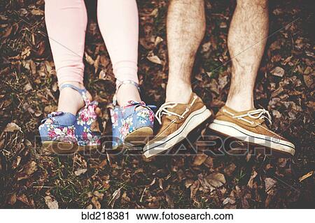 Close up of shoes of couple laying in autumn leaves View Large Photo Image Stock Image - Close up of shoes of couple laying in autumn leaves. Fotosearch