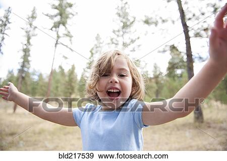 Stock Photo - Close up of smiling Caucasian girl in forest. Fotosearch