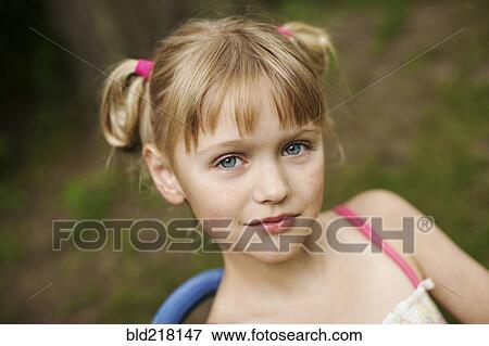 Close up of smiling girl siting in backyard View Large Photo Image Stock Photo - Close up of smiling girl siting in backyard. Fotosearch