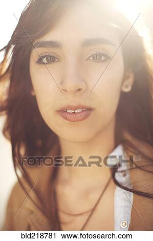 Stock Image - Close up of smiling mixed race woman. Fotosearch