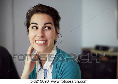 Stock Image - Close up of smiling woman looking up. Fotosearch