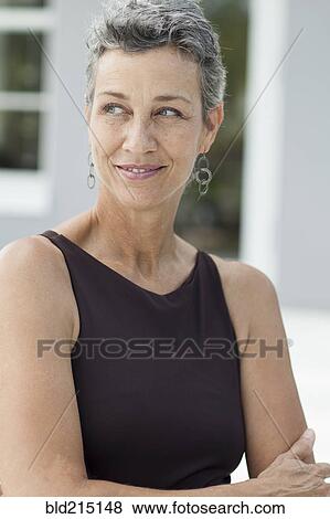 Close up of smiling woman wearing evening gown View Large Photo Image Stock Photo - Close up of smiling woman wearing evening gown. Fotosearch