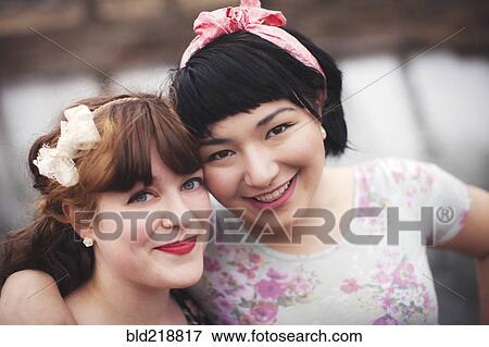 Close up of smiling women hugging View Large Photo Image Stock Photo - Close up of smiling women hugging. Fotosearch