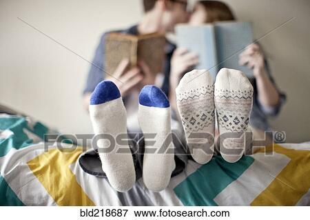 Stock Photo - Close up of socks of couple in bed. Fotosearch