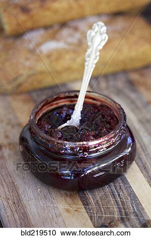 Stock Image - Close up of spoon in jar of jam. Fotosearch