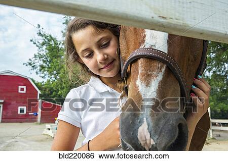 Close up of teenage girl hugging horse on ranch View Large Photo Image Stock Photograph - Close up of teenage girl hugging horse on ranch. Fotosearch
