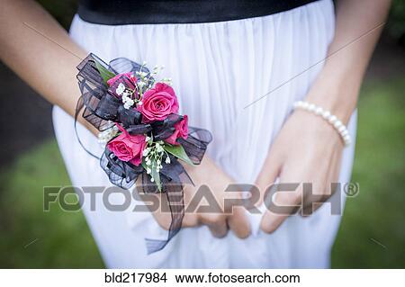Picture - Close up of teenage girl in prom attire wearing corsage. Fotosearch