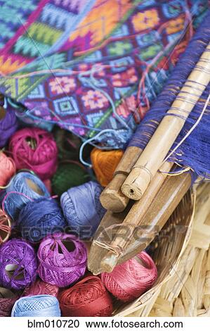 Stock Image - Close up of thread and weaving equipment. Fotosearch