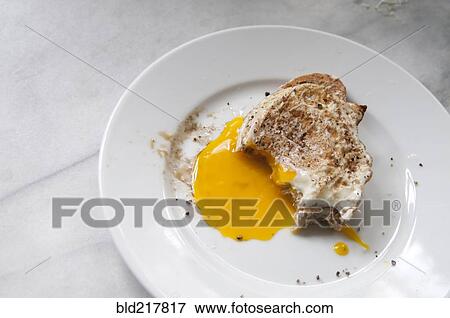 Close up of toast and runny egg yolk breakfast View Large Photo Image Stock Photo - Close up of toast and runny egg yolk breakfast. Fotosearch
