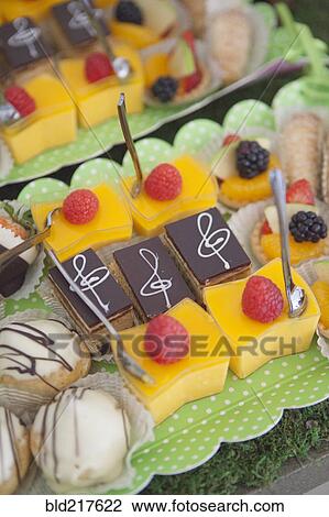 Stock Image - Close up of variety of desserts. Fotosearch