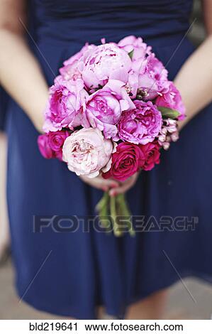 Close up of woman carrying bouquet of flowers View Large Photo Image Stock Image - Close up of woman carrying bouquet of flowers. Fotosearch