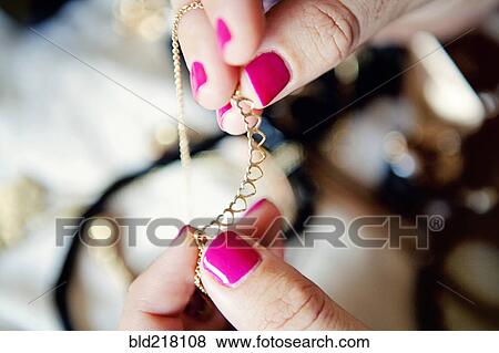 Close up of woman holding jewelry View Large Photo Image Stock Photo - Close up of woman holding jewelry. Fotosearch