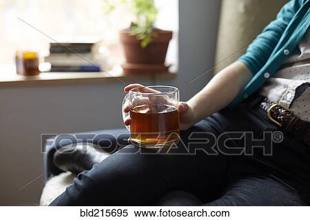 Stock Photography - Close up of woman holding mug of tea. Fotosearch