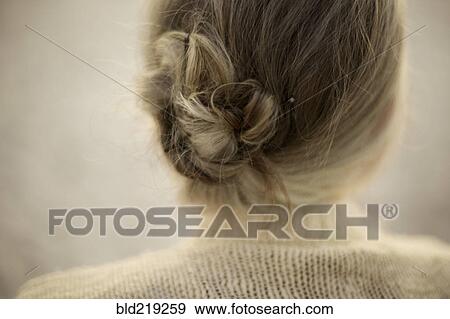 Close up of woman wearing bun and sweater View Large Photo Image Stock Photo - Close up of woman wearing bun and sweater. Fotosearch