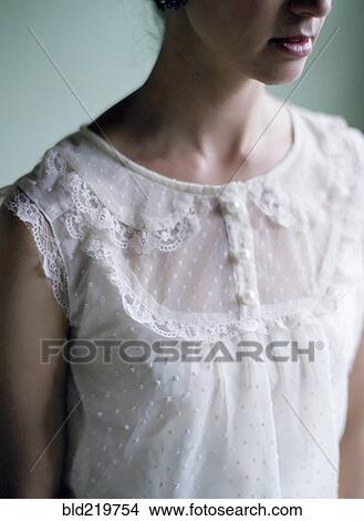 Picture - Close up of woman wearing lace blouse. Fotosearch