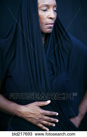 Stock Image - Close up of woman wearing shawl as headscarf. Fotosearch