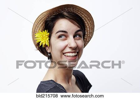 Stock Photo - Close up of woman wearing straw hat. Fotosearch