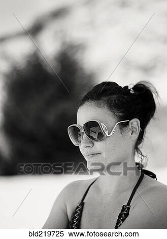 Stock Photography - Close up of woman wearing sunglasses outdoors. Fotosearch
