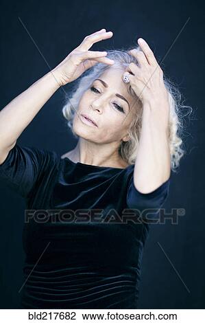 Close up of woman with hands in hair View Large Photo Image Stock Image - Close up of woman with hands in hair. Fotosearch