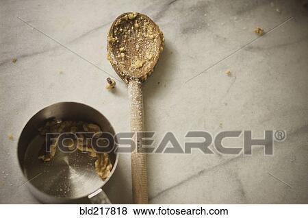 Stock Photo - Close up of wooden spoon and measuring cup. Fotosearch