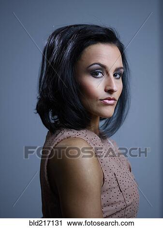 Stock Image - Close up profile of serious Hispanic woman. Fotosearch