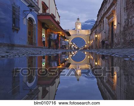 Cobblestone street and arch in quaint town View Large Photo Image Stock Photograph - Cobblestone street and arch in quaint town. Fotosearch