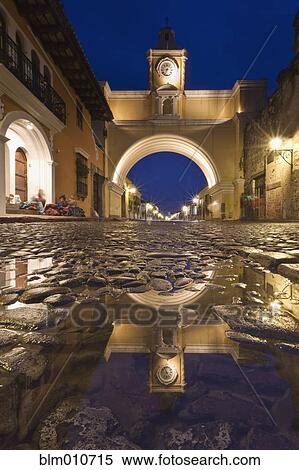 Cobblestone street and arch in quaint town View Large Photo Image Stock Photography - Cobblestone street and arch in quaint town. Fotosearch