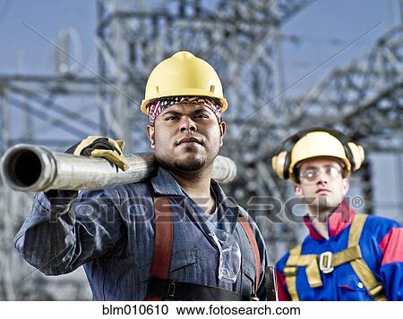 Stock Image - Construction workers standing together. Fotosearch