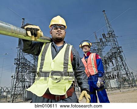 Stock Image - Construction workers standing together. Fotosearch