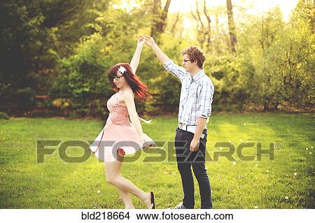 Picture - Couple dancing in grass. Fotosearch