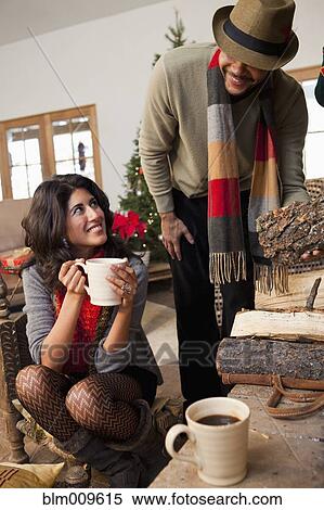 Couple drinking coffee in living room View Large Photo Image Stock Photography - Couple drinking coffee in living room. Fotosearch