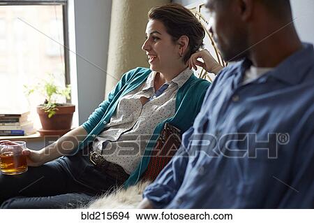 Couple drinking tea in living room View Large Photo Image Picture - Couple drinking tea in living room. Fotosearch