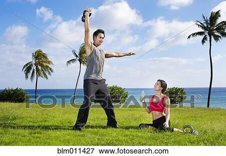 Stock Photo - Couple exercising together at waterfront. Fotosearch
