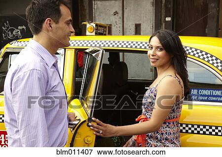 Couple getting into taxi together View Large Photo Image Stock Photo - Couple getting into taxi together. Fotosearch