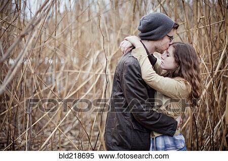 Stock Photography - Couple hugging in branches. Fotosearch