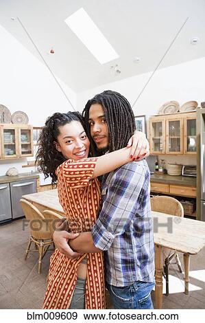 Couple hugging in kitchen View Large Photo Image Stock Photo - Couple hugging in kitchen. Fotosearch