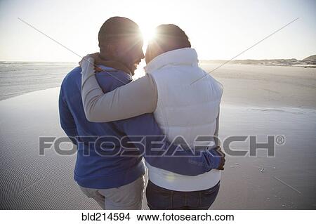 Couple hugging on beach View Large Photo Image Picture - Couple hugging on beach. Fotosearch