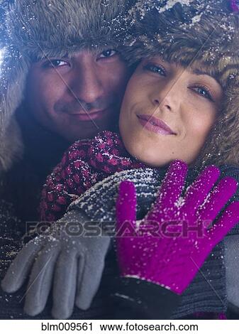 Stock Image - Couple in fur caps hugging. Fotosearch