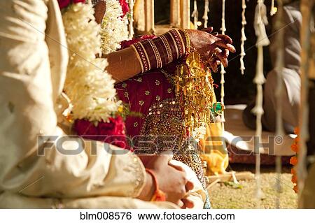 Couple in ornate, traditional Indian wedding clothing View Large Photo Image Stock Photograph - Couple in ornate, traditional Indian wedding clothing. Fotosearch