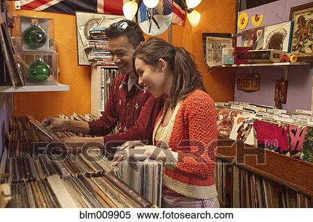 Stock Photography - Couple looking at albums in record store. Fotosearch