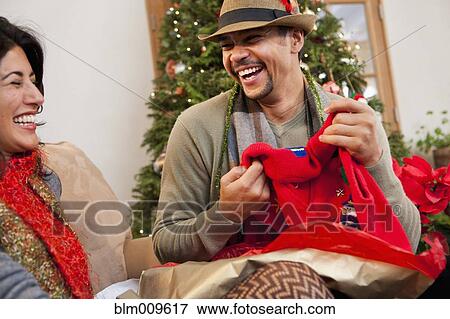 Couple opening Christmas gifts View Large Photo Image Stock Photo - Couple opening Christmas gifts. Fotosearch
