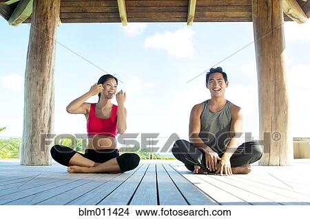 Picture - Couple practicing yoga together. Fotosearch